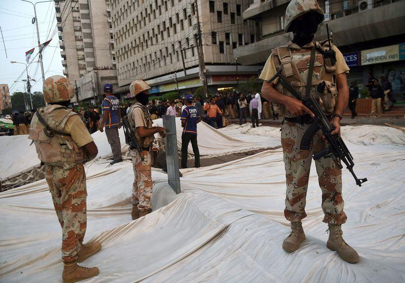 Pakistani paramilitary troops at a demolished MQM protest camp. Photographer: Asif Hassan/AFP/Getty Images