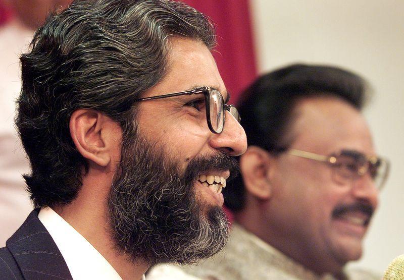 Farooq with Hussain at a press conference in London. Photographer: Jonathan Utz/AFP/Getty Images