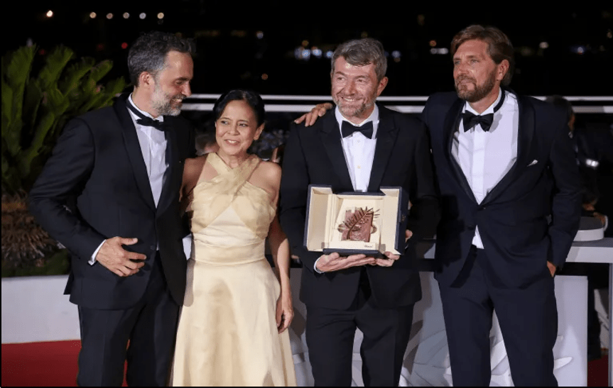 From left: Erik Hemmendorff, Dolly De Leon, Philippe Bobe, and director Ruben Östlund pose with the 2022 Palme d’Or at the Cannes Film Festival